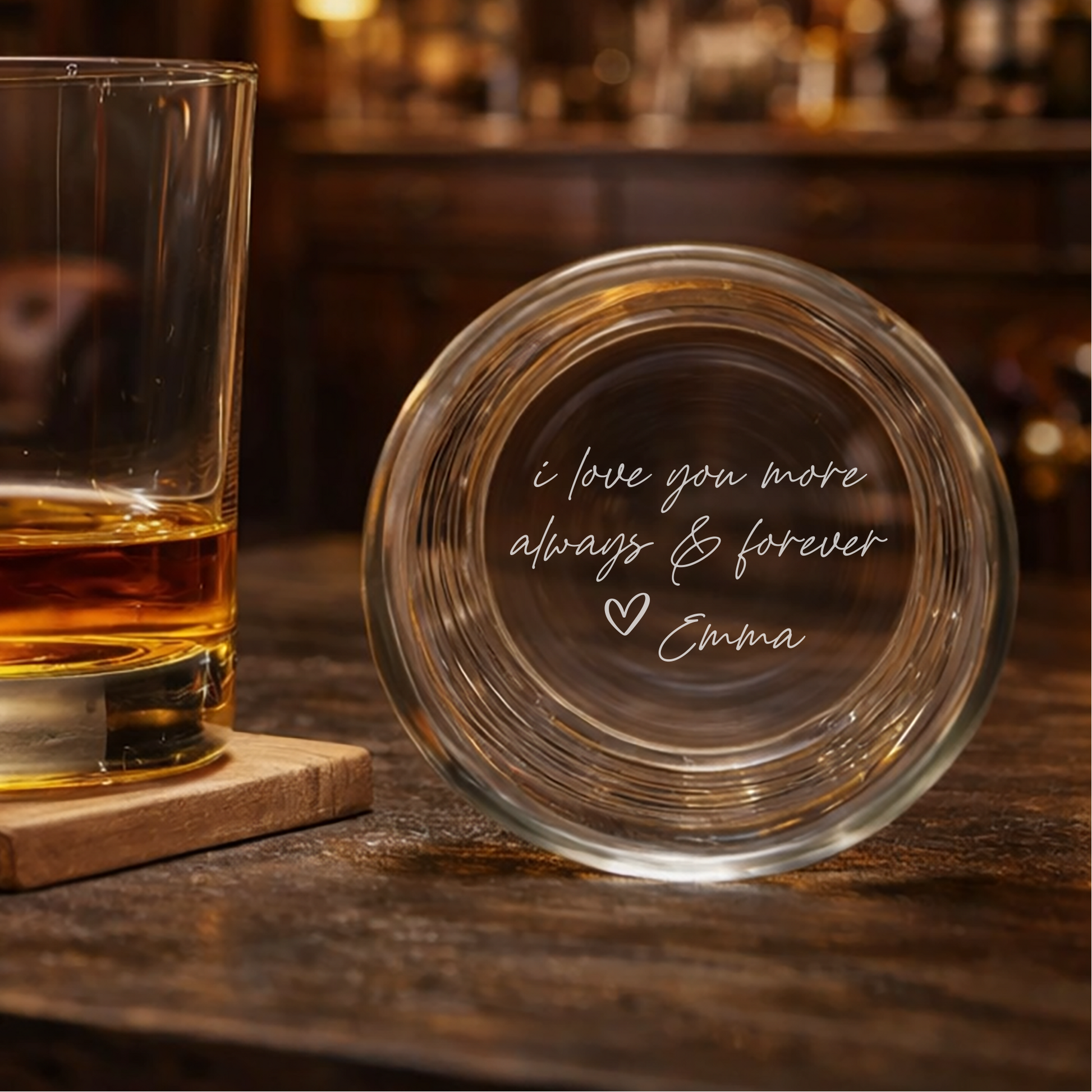 Glass of whiskey on a coaster with an engraved message on a bar background