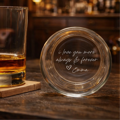 Glass of whiskey on a coaster with an engraved message on a bar background